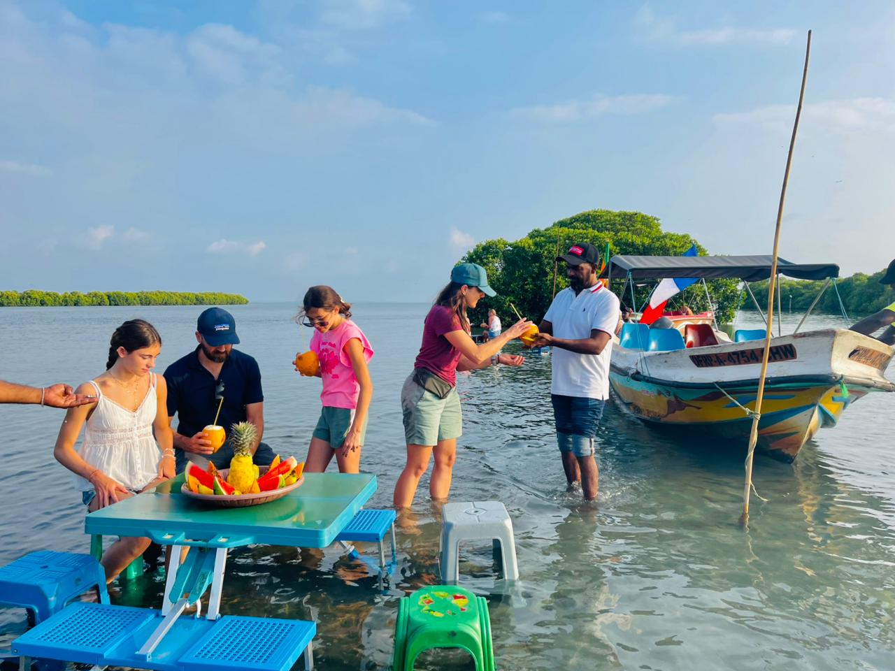 Local boat crew and guests smiling together on the tour
