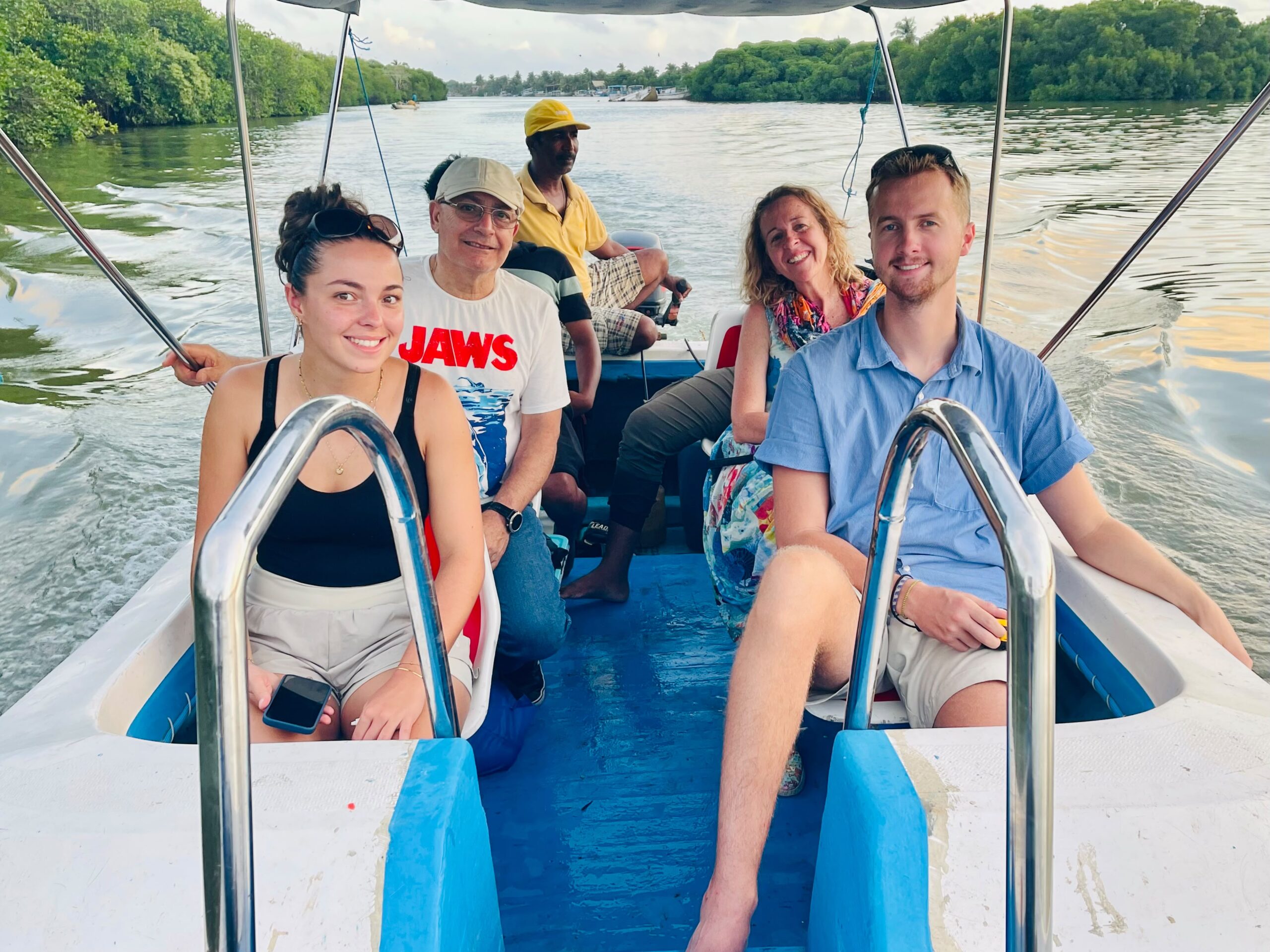 Tourists enjoying a guided boat tour on Negombo Lagoon Sri Lanka with local boat captain