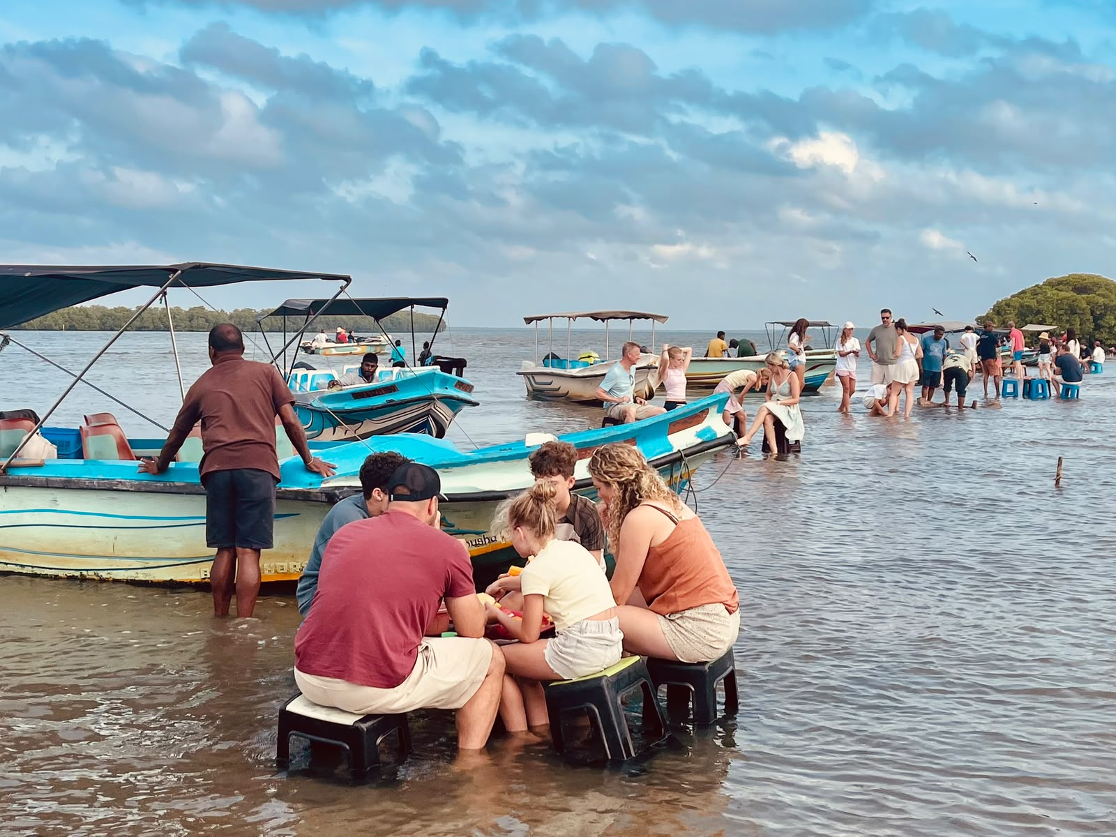 Traditional fishing village on Negombo Lagoon — local fishermen and boats on the waterway during guided tour Sri Lanka