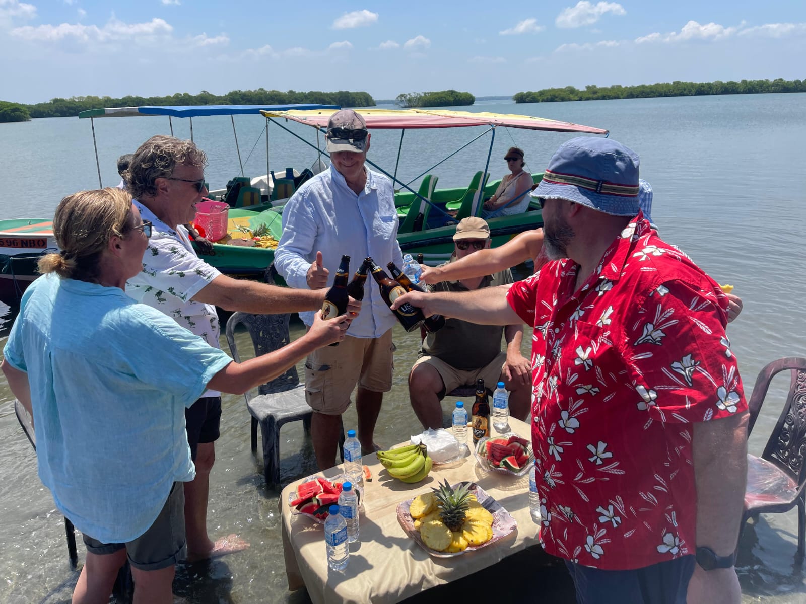 Guests enjoying an all-inclusive guided boat tour in Negombo with welcome drinks and tropical fruit platter
