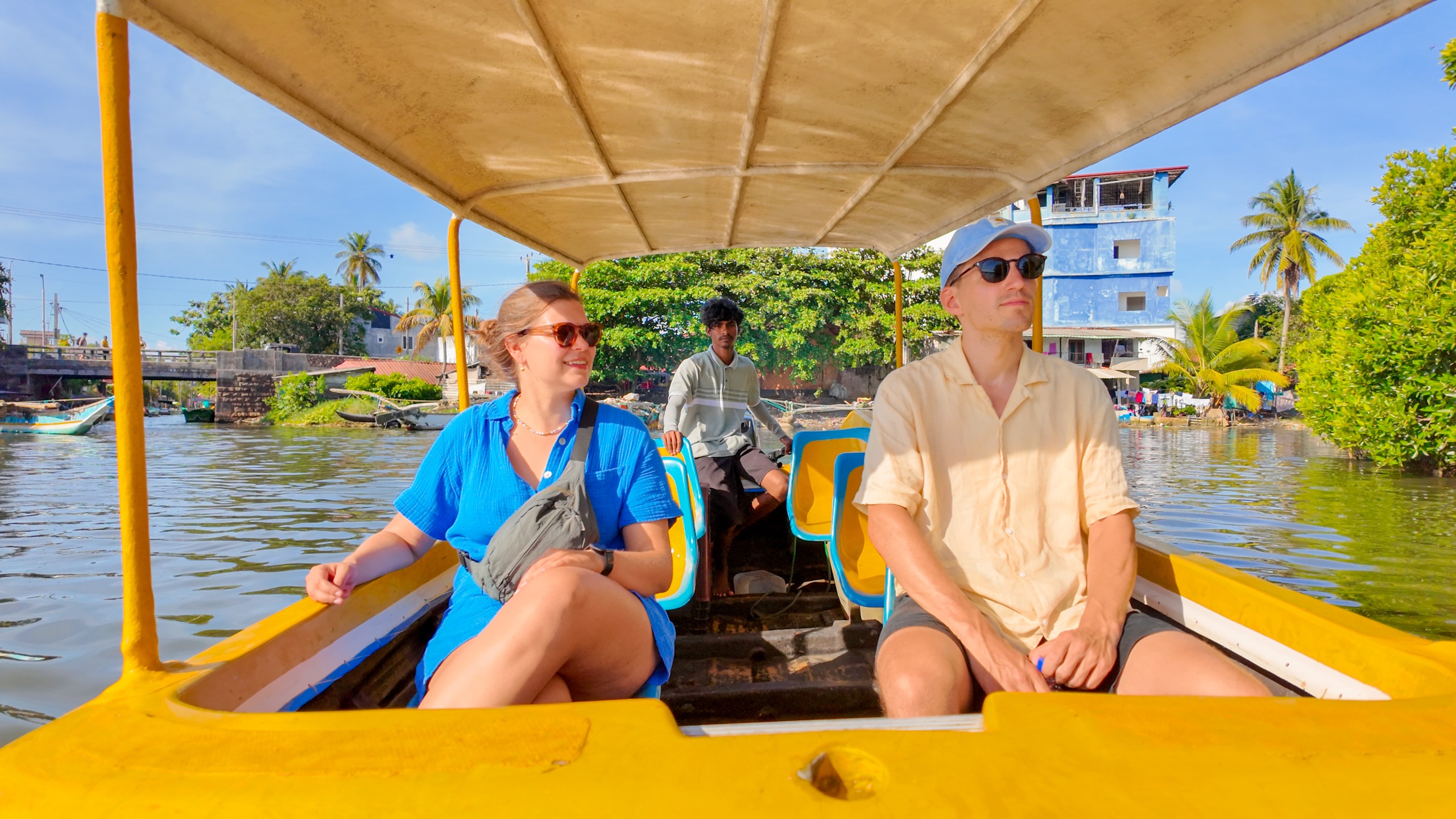 Tourists enjoying a guided boat tour on Negombo Lagoon Sri Lanka with local boat captain