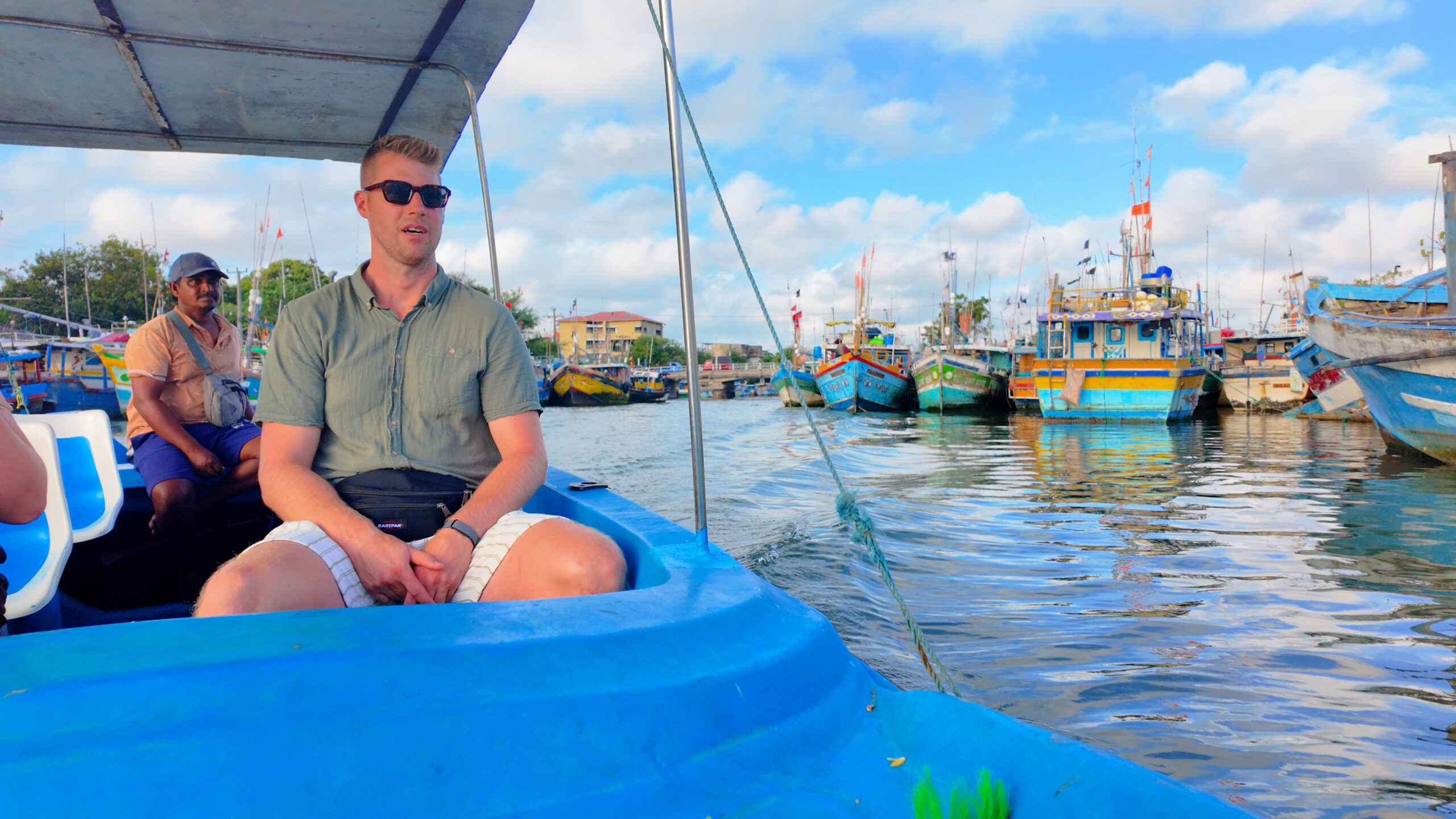 Tourists enjoying a guided boat tour on Negombo Lagoon Sri Lanka with local boat captain
