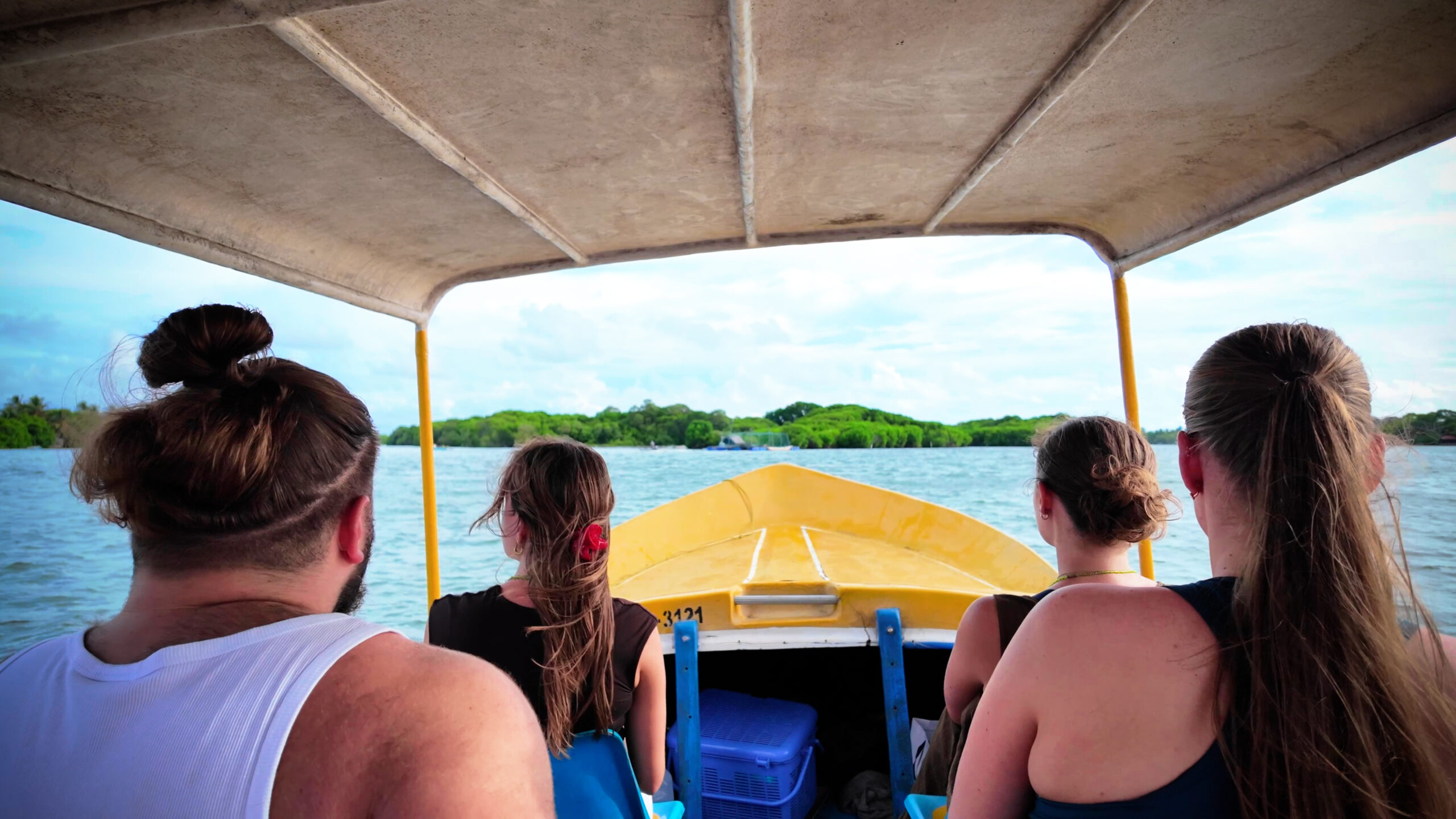 Tourists enjoying a guided boat tour on Negombo Lagoon Sri Lanka with local boat captain